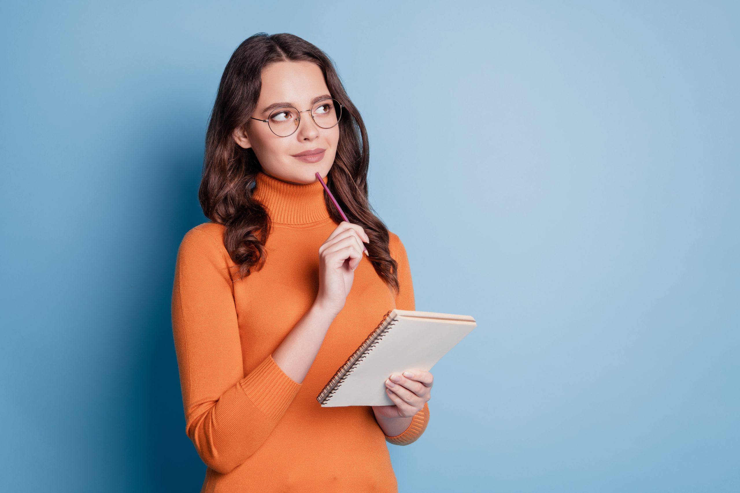 cute woman write notes notepad pen chin look copyspace creative thinking concept 1 scaled