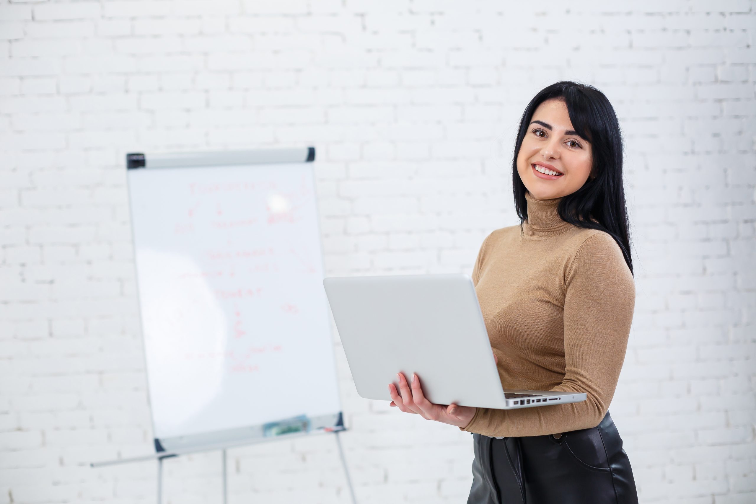 girl businessman teacher trainer teaches talks about new project standing near blackboard scaled